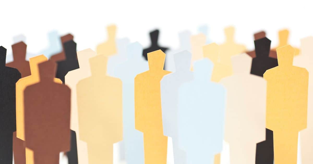 Paper cut outs of people in different colors and shades demonstrating diversity